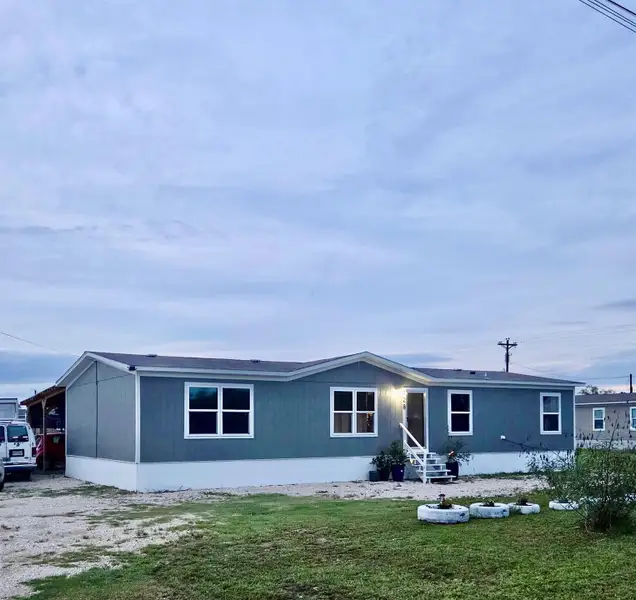 Lighting changes the color of the exterior but its a more subtle grayish. Single-story residence featuring a gray exterior siding and white trim