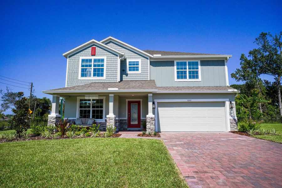 Front exterior of a new home in Enclave At Seminole Palms, Palm Coast, FL, highlighting curb appeal (Image 25). Front exterior of a new home in Enclave At Seminole Palms, Palm Coast, FL, highlighting curb appeal (Image 25).
