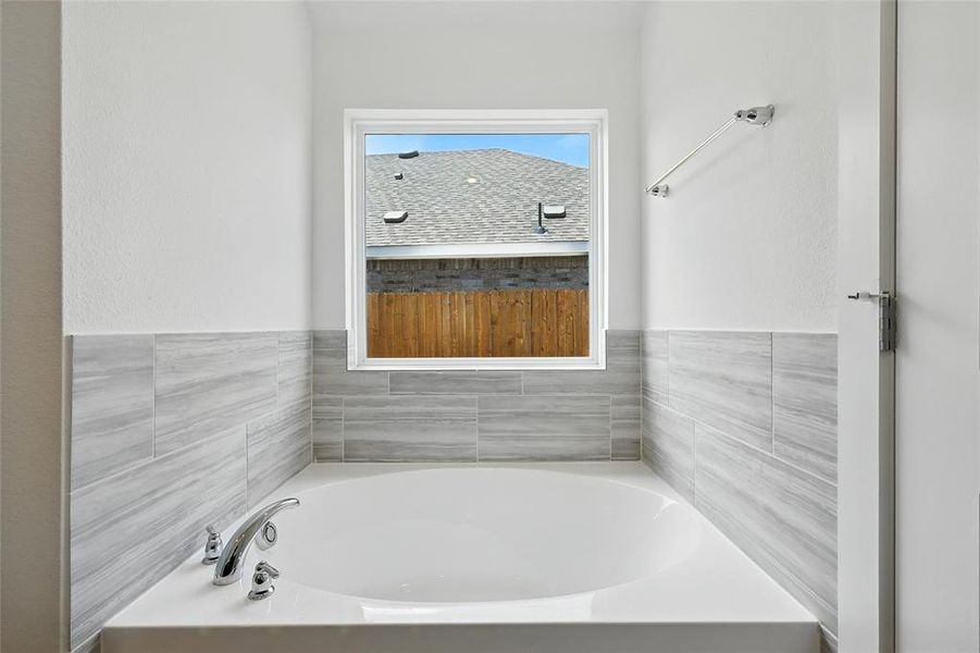 Bathroom featuring a bath Bathroom featuring a bath