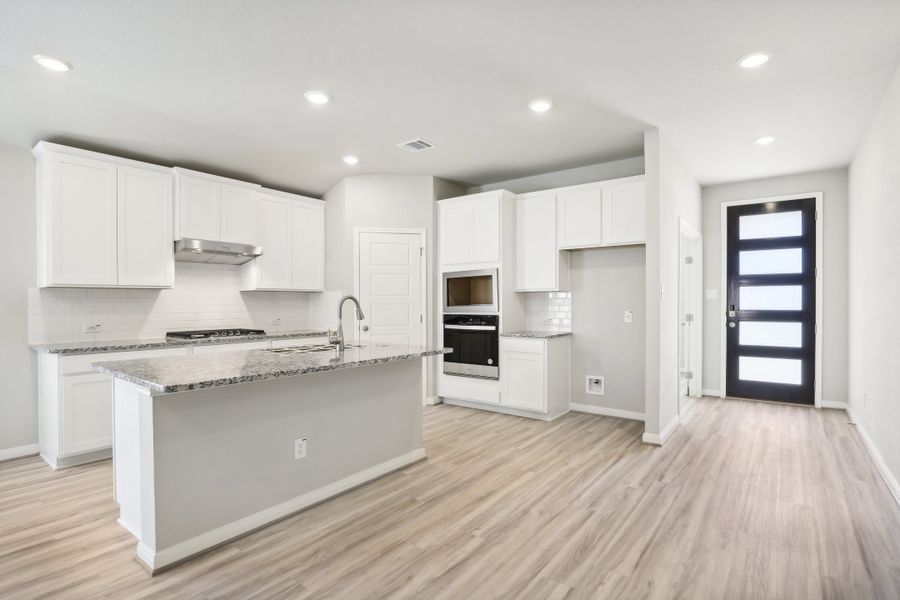 Kitchen and entry in the Oleander floorplan at a Meritage Homes community. Kitchen and entry in the Oleander floorplan at a Meritage Homes community.