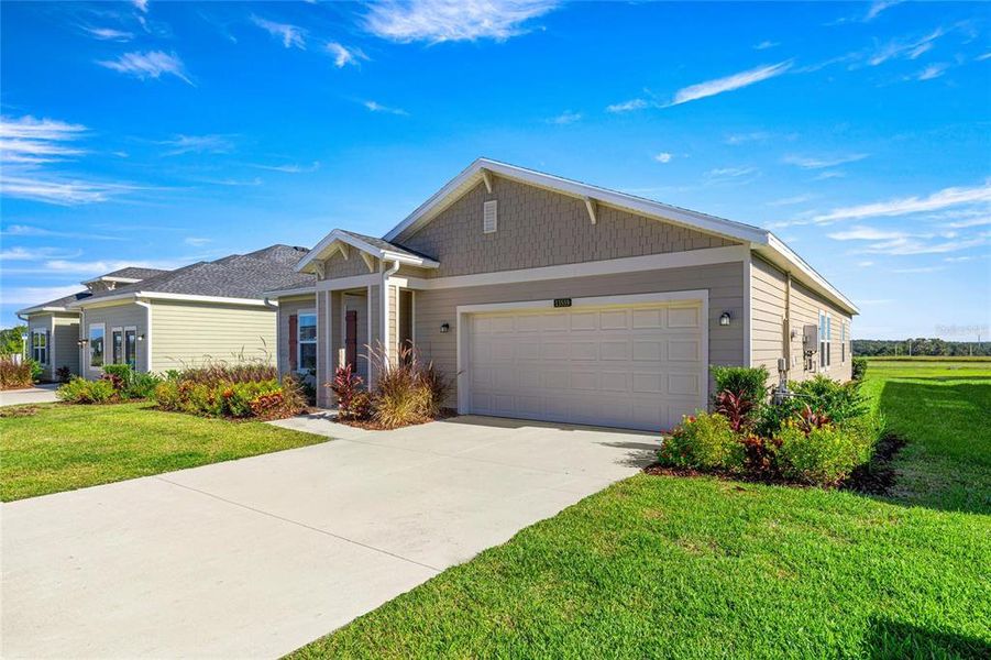 Front exterior of a new home in Pioneer Ranch: Pioneer Ranch 50's, Ocala, FL, highlighting curb appeal (Image 2). Front exterior of a new home in Pioneer Ranch: Pioneer Ranch 50's, Ocala, FL, highlighting curb appeal (Image 2).