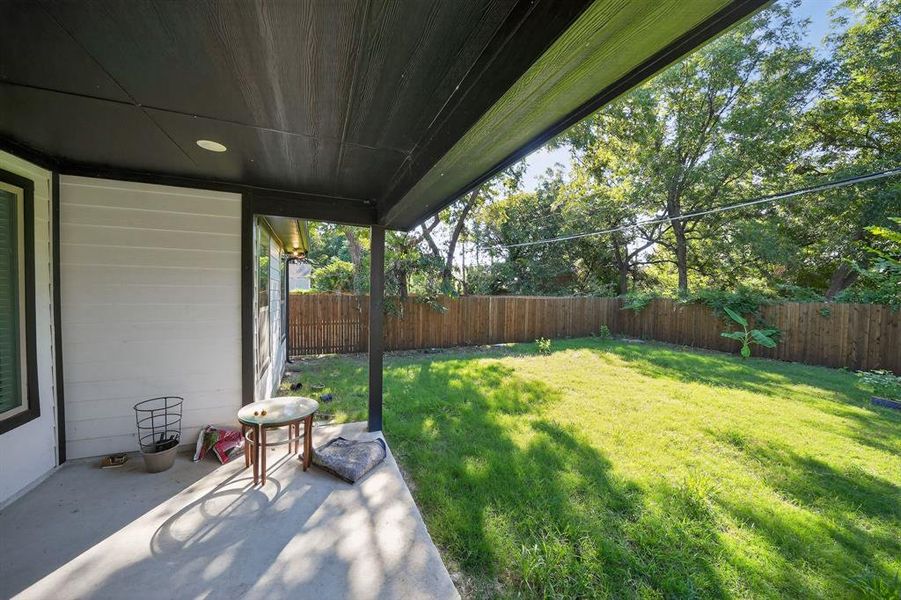 Fenced backyard with a patio