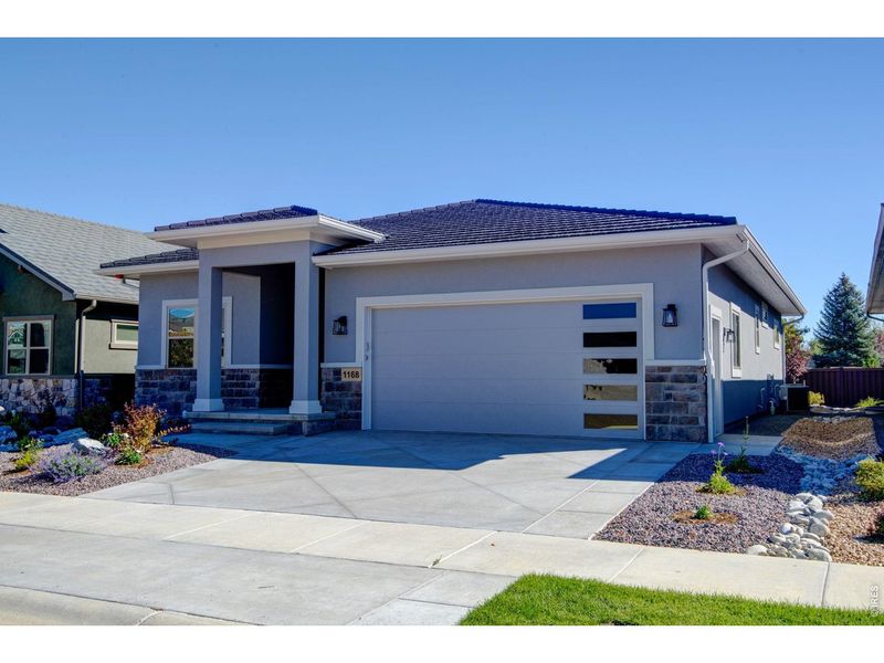 Front exterior of a new home in , Loveland, CO, highlighting curb appeal (Image 1). Front exterior of a new home in , Loveland, CO, highlighting curb appeal (Image 1).