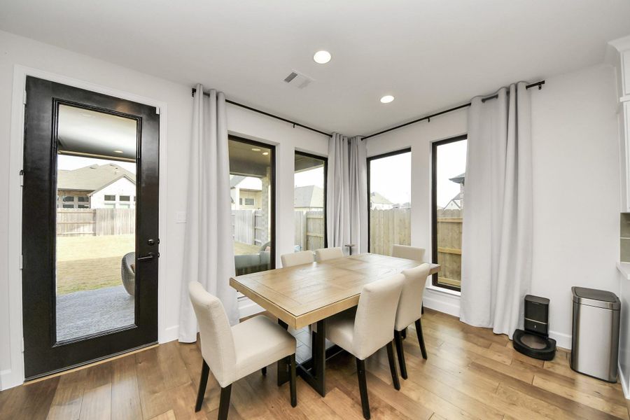 Bright dining space with backyard views and patio access.