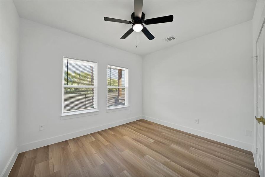 Empty room with light wood-type flooring and ceiling fan