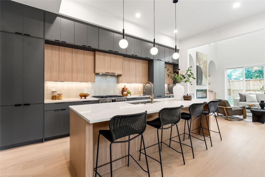 This oversized kitchen features luxury Bosch appliances, Taj Mahal counters, and more than enough storage space with three layers of European soft close cabinetry. This oversized kitchen features luxury Bosch appliances, Taj Mahal counters, and more than enough storage space with three layers of European soft close cabinetry.