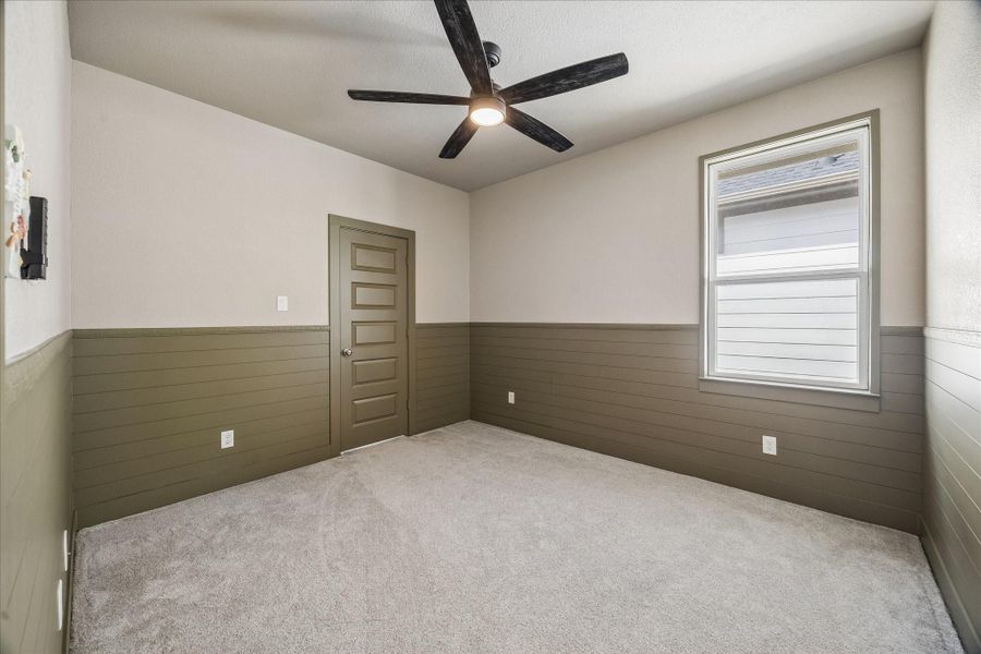 This additional secondary bedroom provides ample space and closet storage, making it perfect for a growing household or visiting guests.