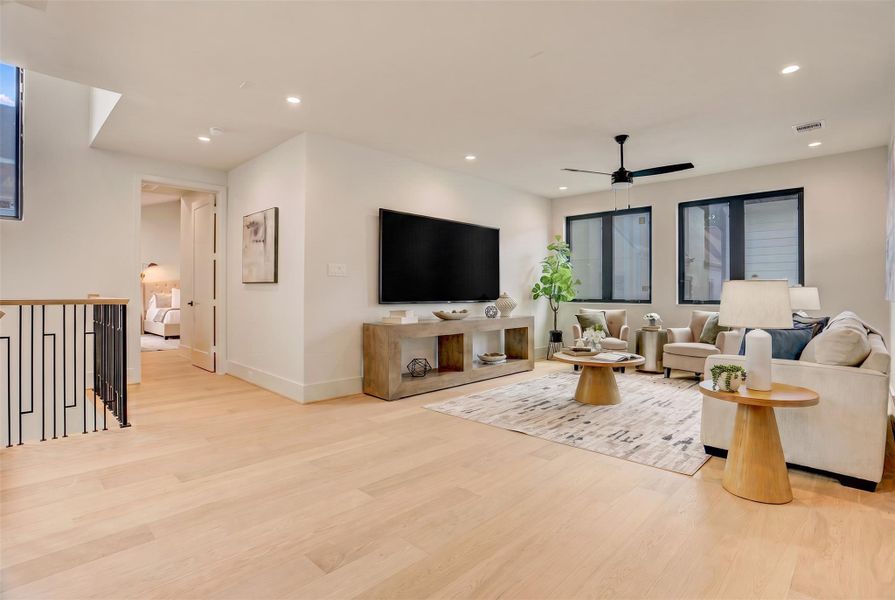 At the top of the stairs on the second floor, enjoy a family room, allowing you to utilize living spaces on each floor of the property.