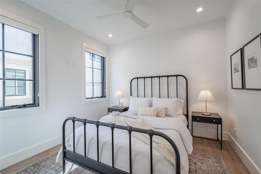 Bedroom with light hardwood flooring and ceiling fan