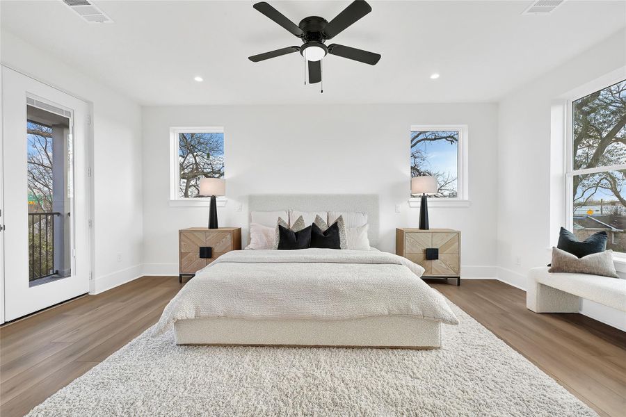 Primary suite with high ceilings, abundant natural light and balcony access.