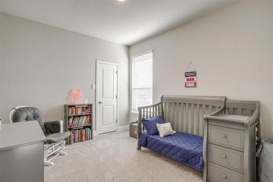 Bedroom featuring light carpet