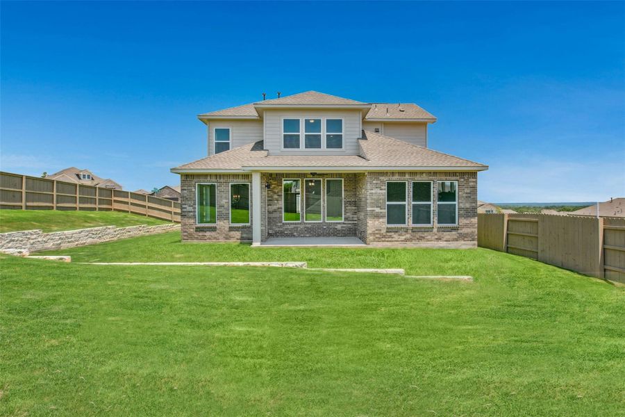 Front exterior of a new home in The Colony, Bastrop, TX, highlighting curb appeal (Image 16). Front exterior of a new home in The Colony, Bastrop, TX, highlighting curb appeal (Image 16).