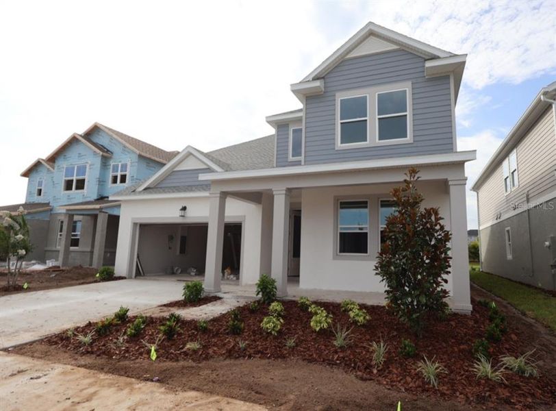 Front exterior of a new home in Waterset Classic Series, Apollo Beach, FL, highlighting curb appeal (Image 1). Front exterior of a new home in Waterset Classic Series, Apollo Beach, FL, highlighting curb appeal (Image 1).