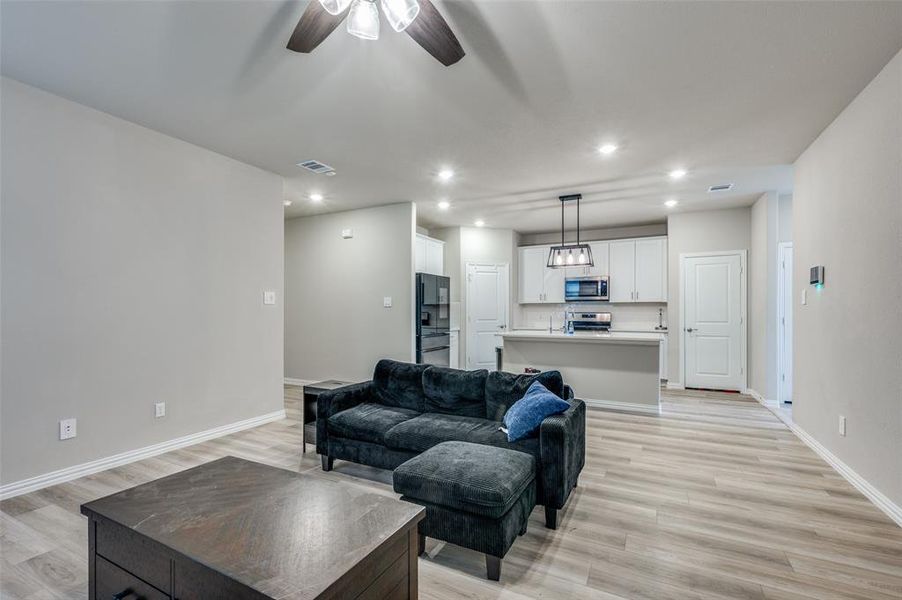 Living area featuring recessed lighting, light wood finished floors, and ceiling fan