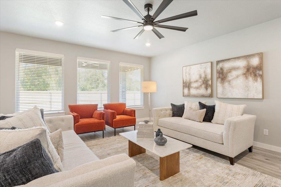 Living room featuring light wood-style floors, a ceiling fan, and recessed lighting Living room featuring light wood-style floors, a ceiling fan, and recessed lighting