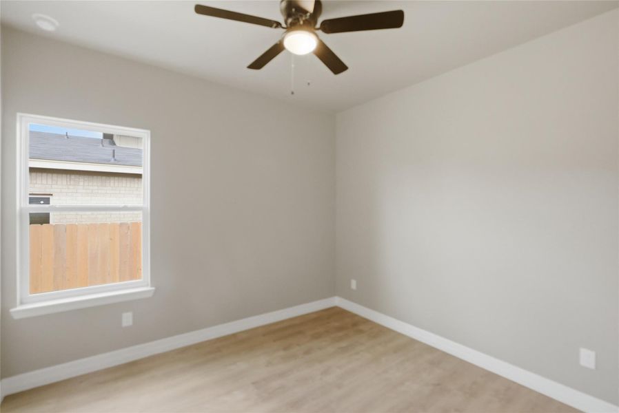 Empty room featuring light wood-type flooring and ceiling fan