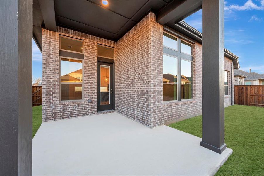 Fenced backyard with a patio