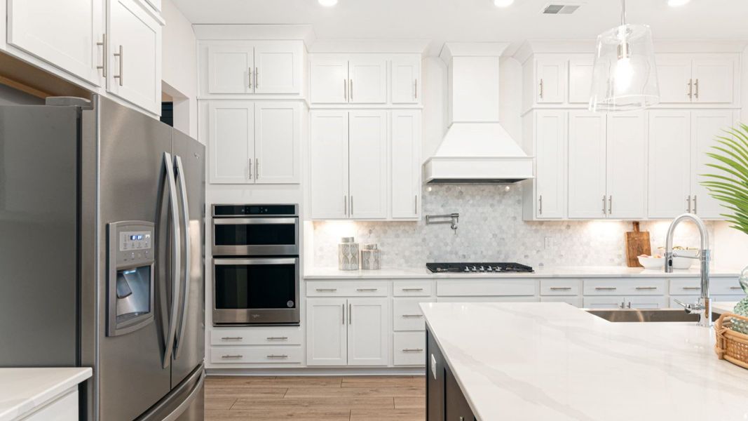 large kitchen island with backsplash detail and pot filler