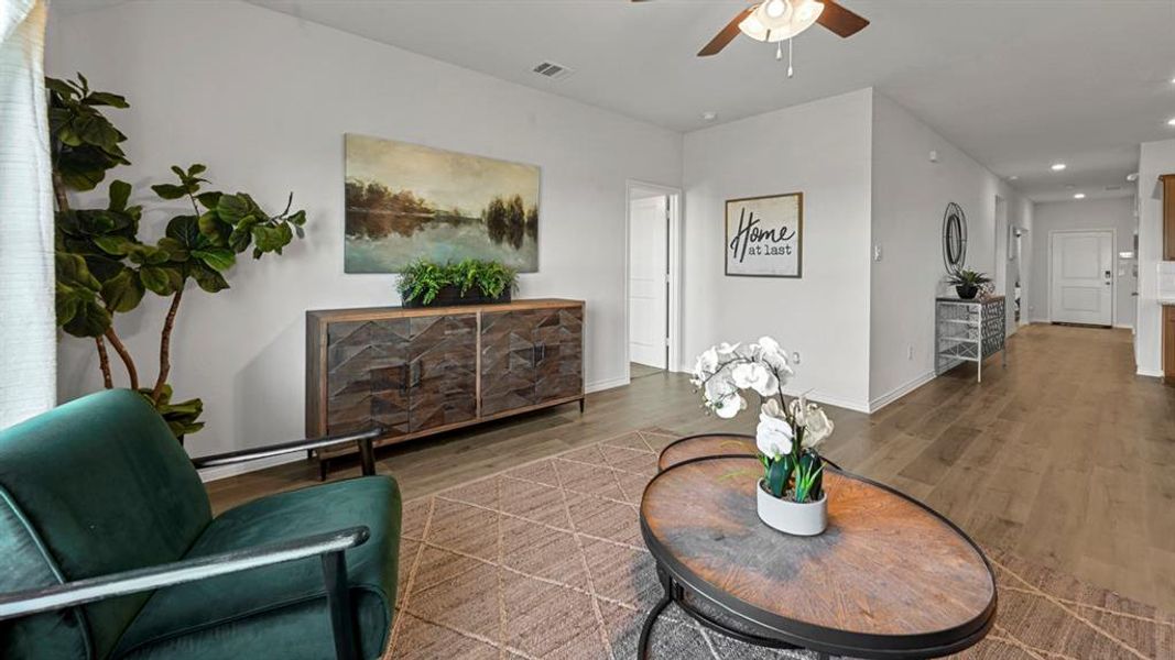 Living area with a ceiling fan, wood finished floors, and recessed lighting