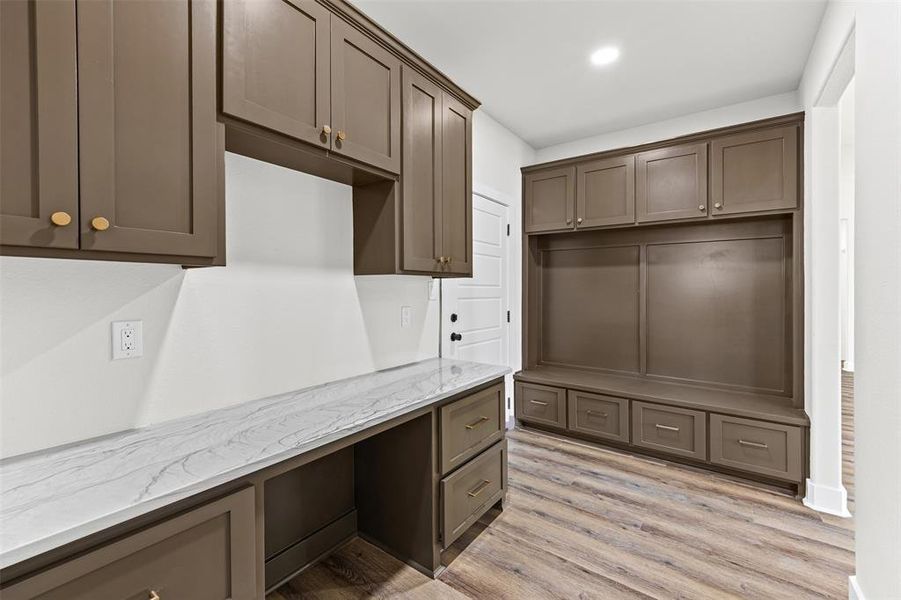 Mud Room with built in desk, light wood finished floors, and recessed lighting Mud Room with built in desk, light wood finished floors, and recessed lighting