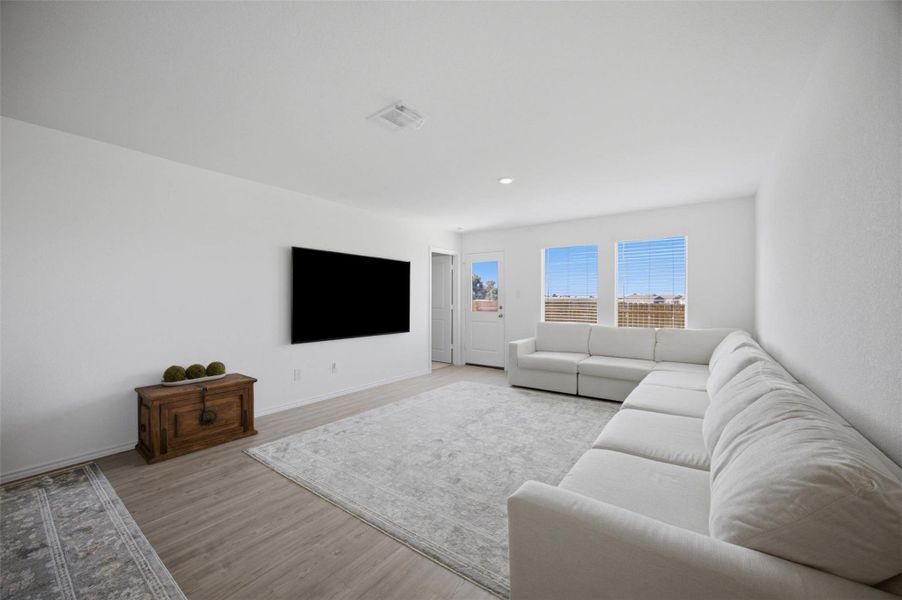 Clean lines and smooth flooring define this airy living space illuminated by natural light.
