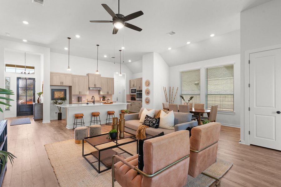 High ceilings and recessed lighting elevate this open floorplan flowing seamlessly from living to dining areas.