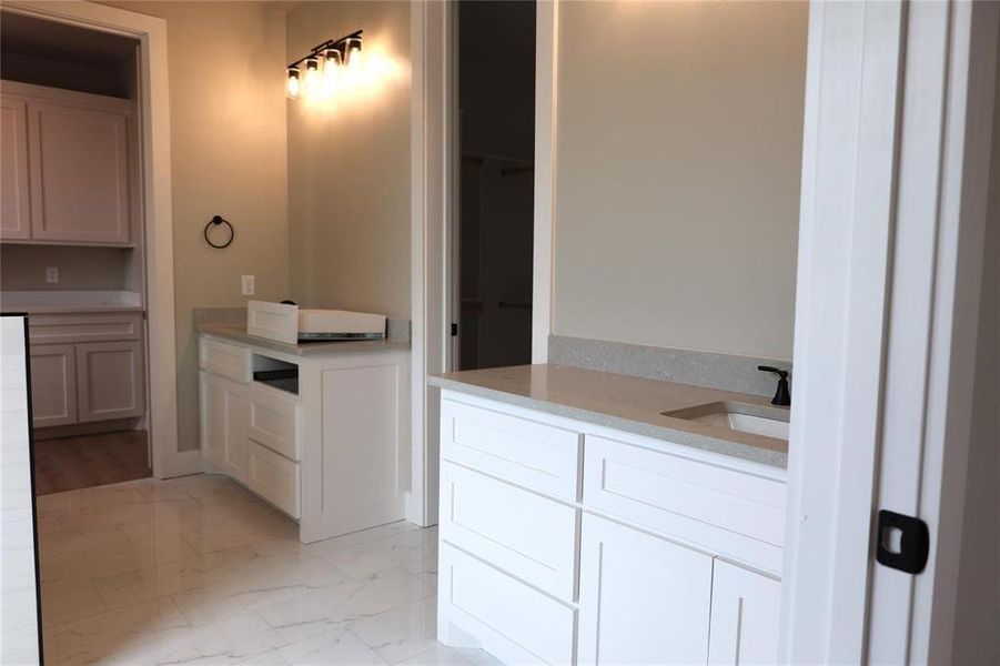 Bathroom with sink and tile patterned flooring