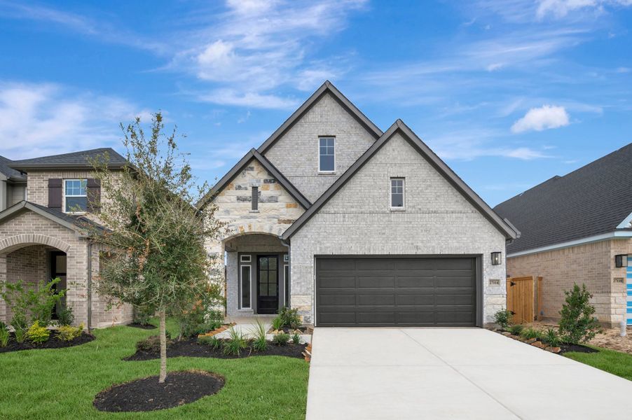 Front exterior of a new home in The Grand Prairie - Meadow Collection, Hockley, TX, highlighting curb appeal (Image 2). Front exterior of a new home in The Grand Prairie - Meadow Collection, Hockley, TX, highlighting curb appeal (Image 2).