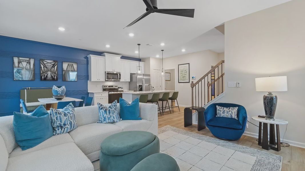 Open concept kitchen and family room in new construction townhome at Auburn Ridge with seamless flow and natural light.