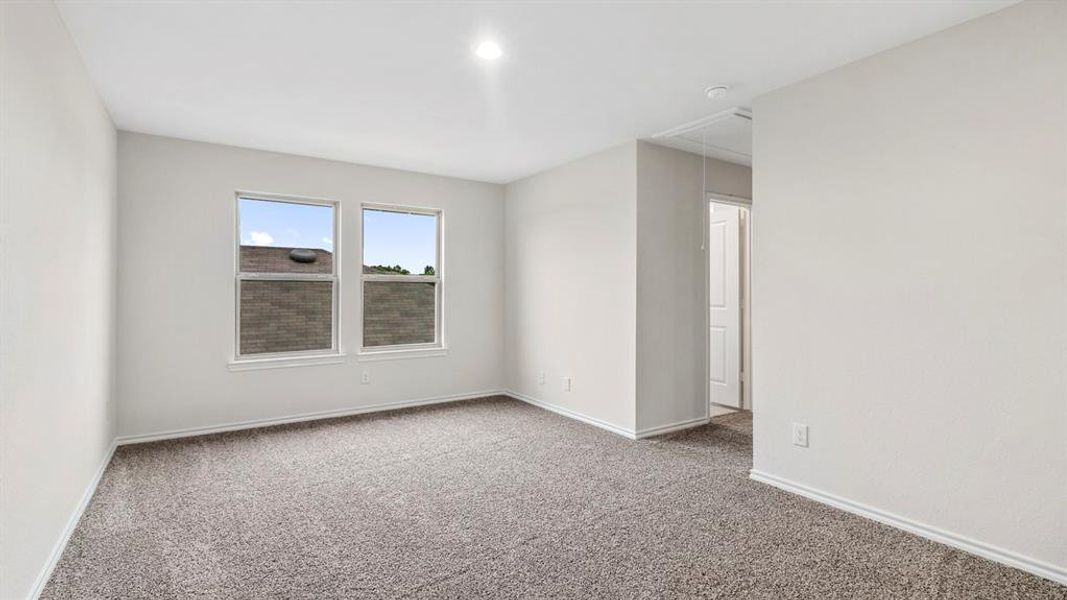 Room featuring neutral gray carpeting and light-toned wall paint