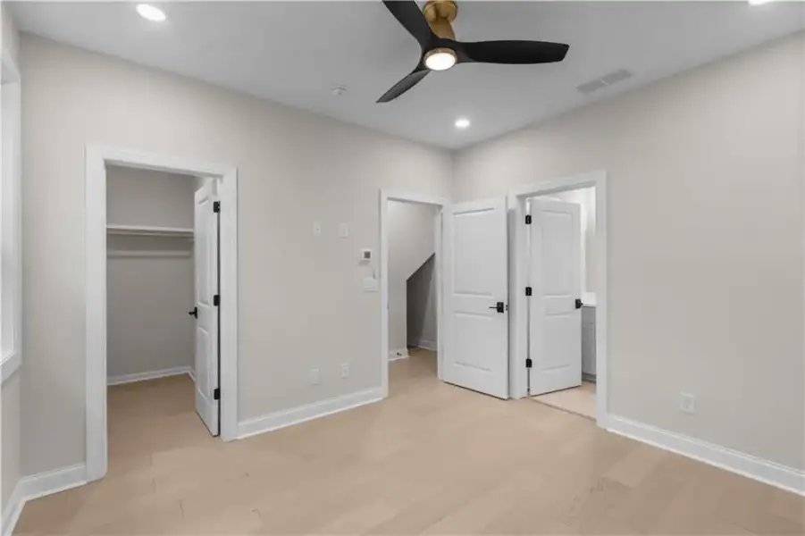 Recessed lighting, wood-finish flooring, and a modern ceiling fan with integrated lighting