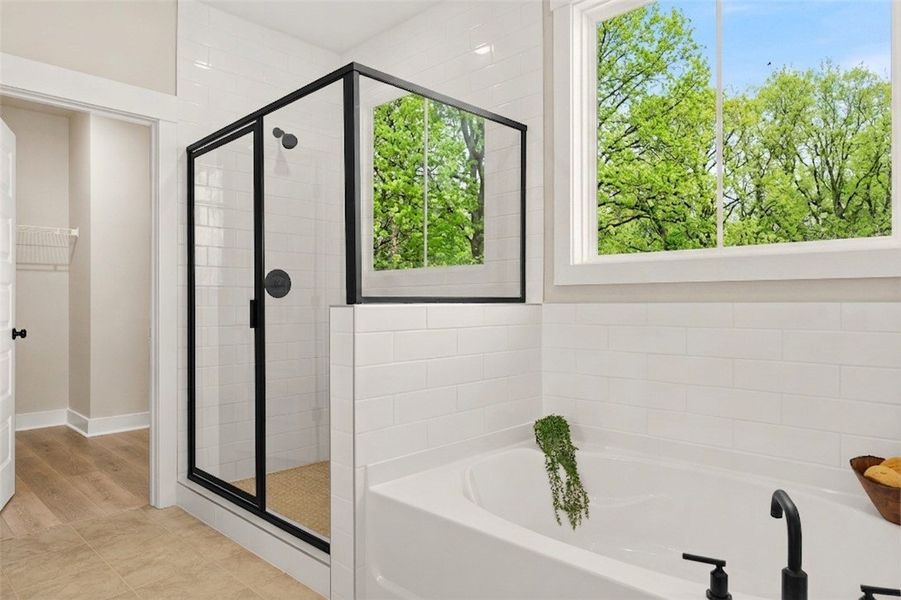 This bright bathroom features a spacious soaking t