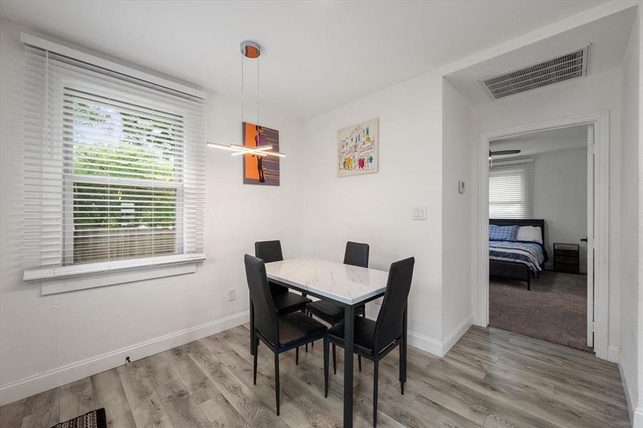 Dining space featuring healthy amount of natural light and wood finished floors Dining space featuring healthy amount of natural light and wood finished floors