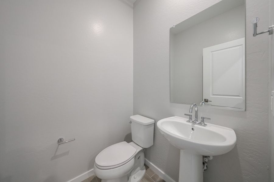 A bathroom with a toilet and sink.