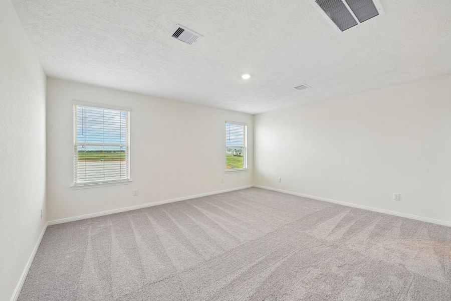 Relax and recharge in this stunning primary suite! Enjoy the comfort of plush carpeting, neutral-toned walls, high ceilings, recessed lighting, and large windows with fitted blinds that fill the room with natural light.