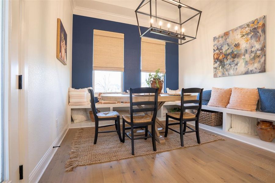 Dining area featuring hardwood / wood-style floors and suspended lighting Dining area featuring hardwood / wood-style floors and suspended lighting