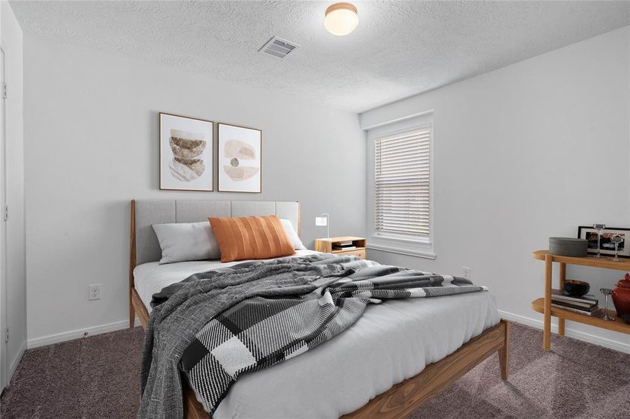 Secondary bedroom features plush carpet, neutral paint, lighting, large window with privacy blinds and ample sized closet space.