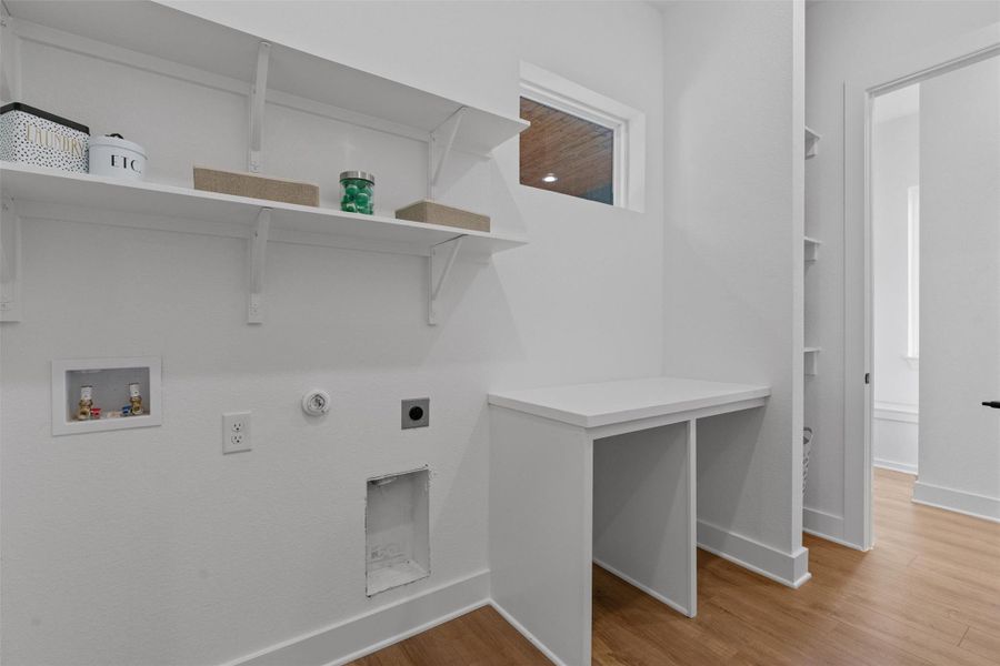 A well-appointed laundry room features practical shelving and ample counter space for household tasks. A well-appointed laundry room features practical shelving and ample counter space for household tasks.