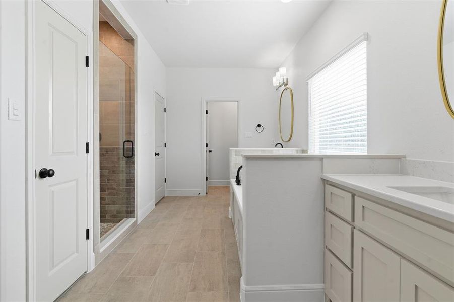 Full bath with a stall shower, a garden tub, and two vanities Full bath with a stall shower, a garden tub, and two vanities