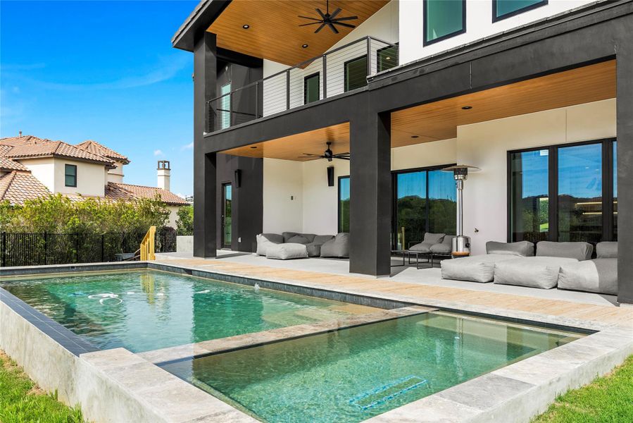 Back of property with ceiling fan, a balcony, an outdoor lounge area, and a patio area Back of property with ceiling fan, a balcony, an outdoor lounge area, and a patio area