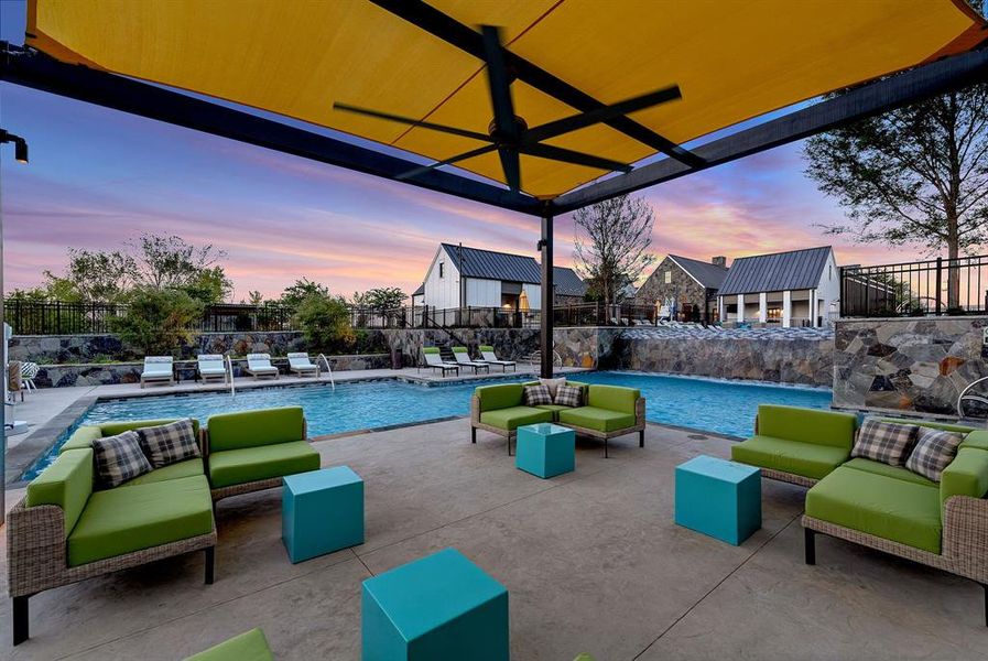Pool at dusk featuring a patio and outdoor lounge area Pool at dusk featuring a patio and outdoor lounge area