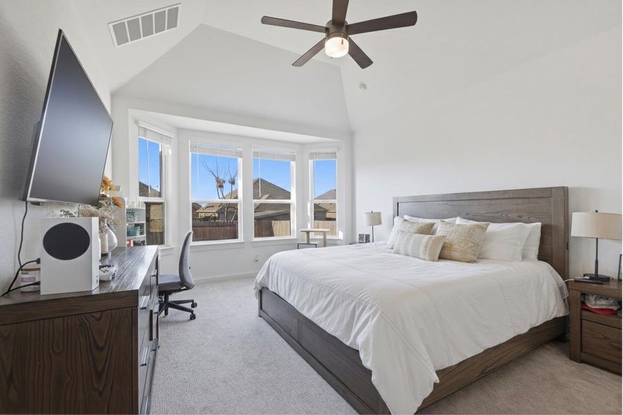 Bedroom featuring a desk, carpet, ceiling fan, and vaulted ceiling