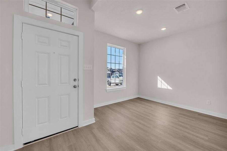 Foyer entrance featuring visible vents, recessed lighting, baseboards, and wood finished floors