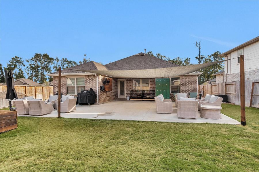 View of the back of the home showing the extended back patio