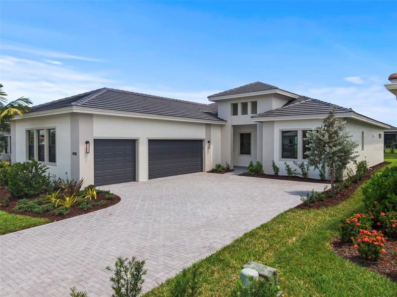 Front exterior of a new home in Cresswind Lakewood Ranch, Lakewood Ranch, FL, highlighting curb appeal (Image 1).