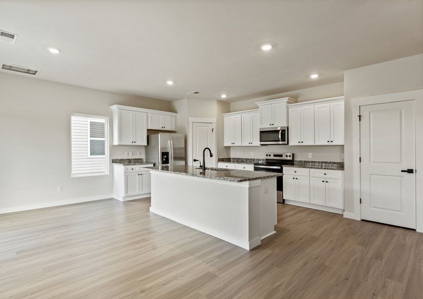 The kitchen has designer wood cabinetry