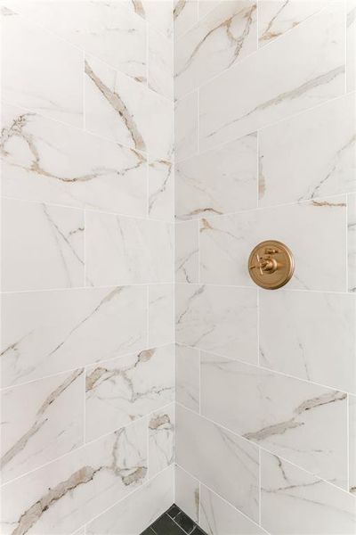 Full bath featuring tiled shower