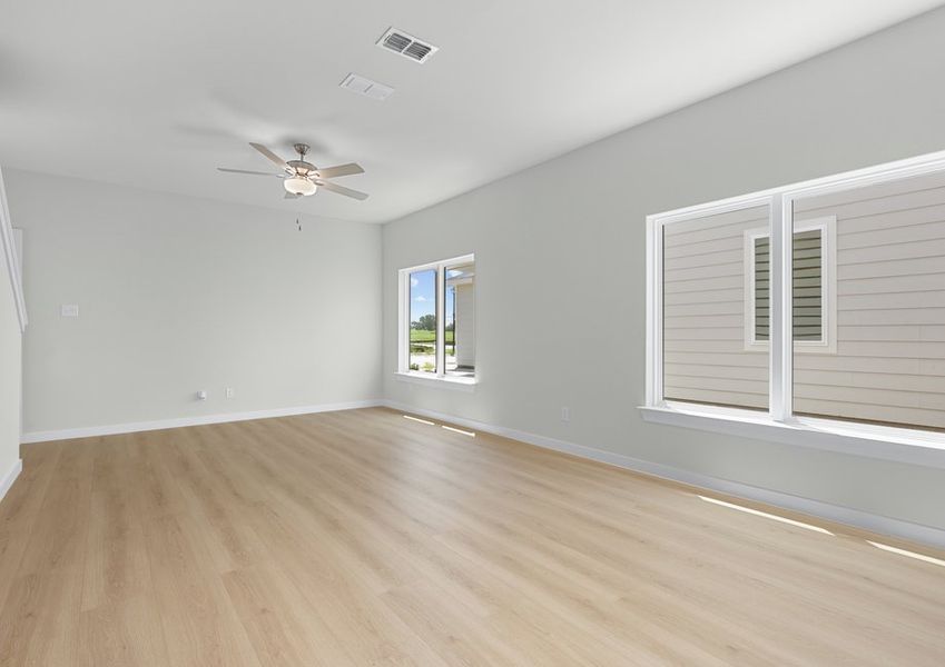 The open living room has large windows for natural light. The open living room has large windows for natural light.