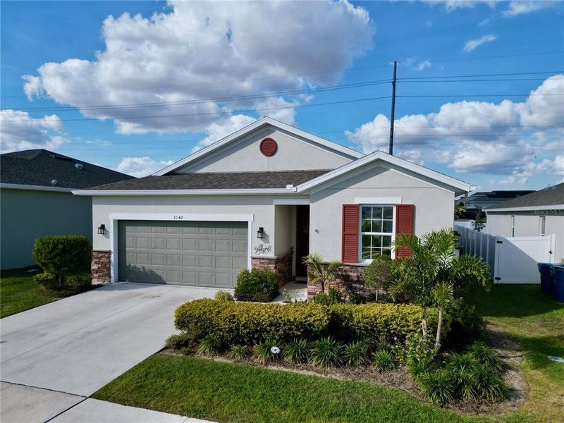 Front exterior of a new home in Seasons at Heritage Square, Haines City, FL, highlighting curb appeal (Image 28). Front exterior of a new home in Seasons at Heritage Square, Haines City, FL, highlighting curb appeal (Image 28).
