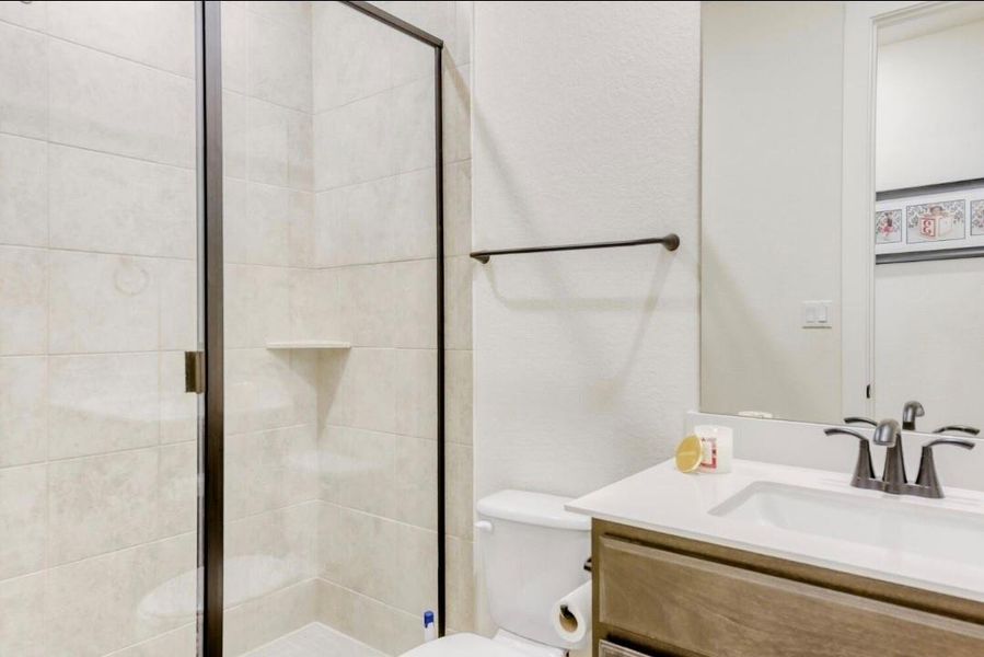 Full bathroom featuring vanity and a stall shower